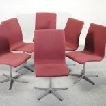 A set of six 1970's Danish swivel dining chairs, with red upholstered seats,