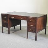 A mid 20th century stained oak desk, with an inset writing surface,