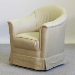 An Edwardian green upholstered tub shaped armchair