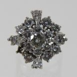 An unmarked diamond cluster ring, the central stone approximately 0.