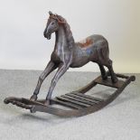 An antique style painted wooden rocking horse,