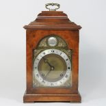 A reproduction walnut cased bracket clock, with an eight day Imperial movement,