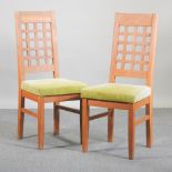 A set of seven modern light oak dining chairs,