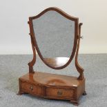 A George III style walnut swing frame toiletry mirror,