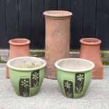 A terracotta chimney pot, 71cm high, together with two others smaller,