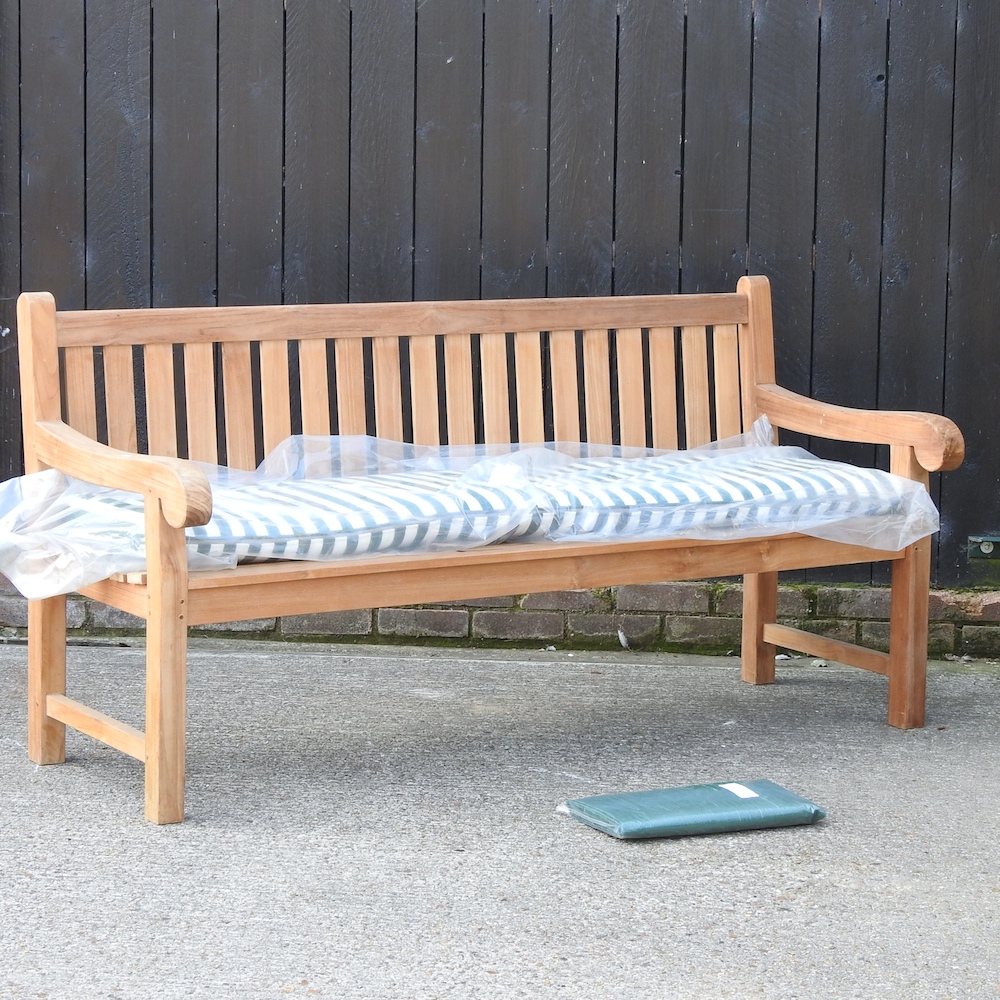 A teak slatted garden bench,