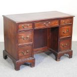 A 20th century mahogany pedestal desk, containing an arrangement of short drawers,