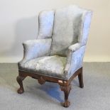 A 20th century upholstered wing armchair, of George I style,