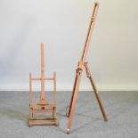 A wooden artist's table top easel, together with another easel,