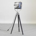 A modern chrome stagelight, on a tripod base,