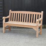 A teak slatted garden bench, with a loose cushion,