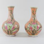A pair of Chinese porcelain pink glazed gourd vases, painted with flowers,