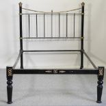 An early 20th century brass and iron bedstead,