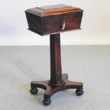 A Regency rosewood teapoy, with a fitted interior, on a quadruped base,