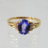 An 18 carat gold, tanzanite and amethyst ring, size R, 3.