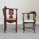 A carved hardwood corner chair, with a cane seat,