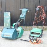 A Qualcast Suffolk punch petrol lawnmower, together with a Qualcast electric scarifier,