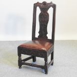 An 18th century carved oak chair, with dragon and foliate decoration,