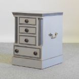 A grey and green painted bedside chest, containing four drawers, with brass handles,