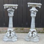 A near pair of ornate metal garden stands,