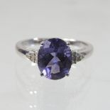 A 9 carat gold, tanzanite and diamond ring, size R, 4g gross,