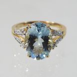 An unmarked topaz and diamond ring, with open diamond set shoulders, size R, 4.