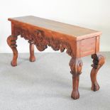 A carved pine serving table, on cabriole legs,