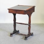 A small Victorian rosewood desk, on shaped supports,