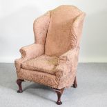 A Victorian carved mahogany and upholstered armchair,