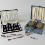 A set of early 20th century silver backed brushes, cased, together with a set of silver teaspoons,