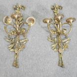 A pair of brass ornate three branch wall sconces,