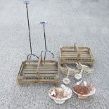 A pair of white painted cast iron bird baths, together with two wooden crates,
