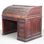 An early 20th century mahogany desk, with a tambour top,