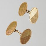 A pair of 18 carat gold cufflinks, of oval shape with engraved decoration, 6.