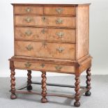 A Queen Anne walnut chest on a later stand, having two short over three long graduated drawers,