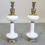 A pair of white opaque glass and brass table lamps,