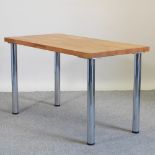 A modern oak table, on chrome legs,