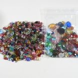 A collection of unmounted gemstones and coloured glass beads