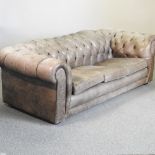 A green leather upholstered button back chesterfield sofa,