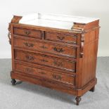 A 19th century French walnut marble top commode, on turned feet,