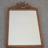 A wooden framed wall mirror, surmounted by a lyre,
