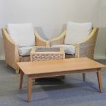 A pair of wicker arm chairs, together with a matching coffee table and another coffee table,