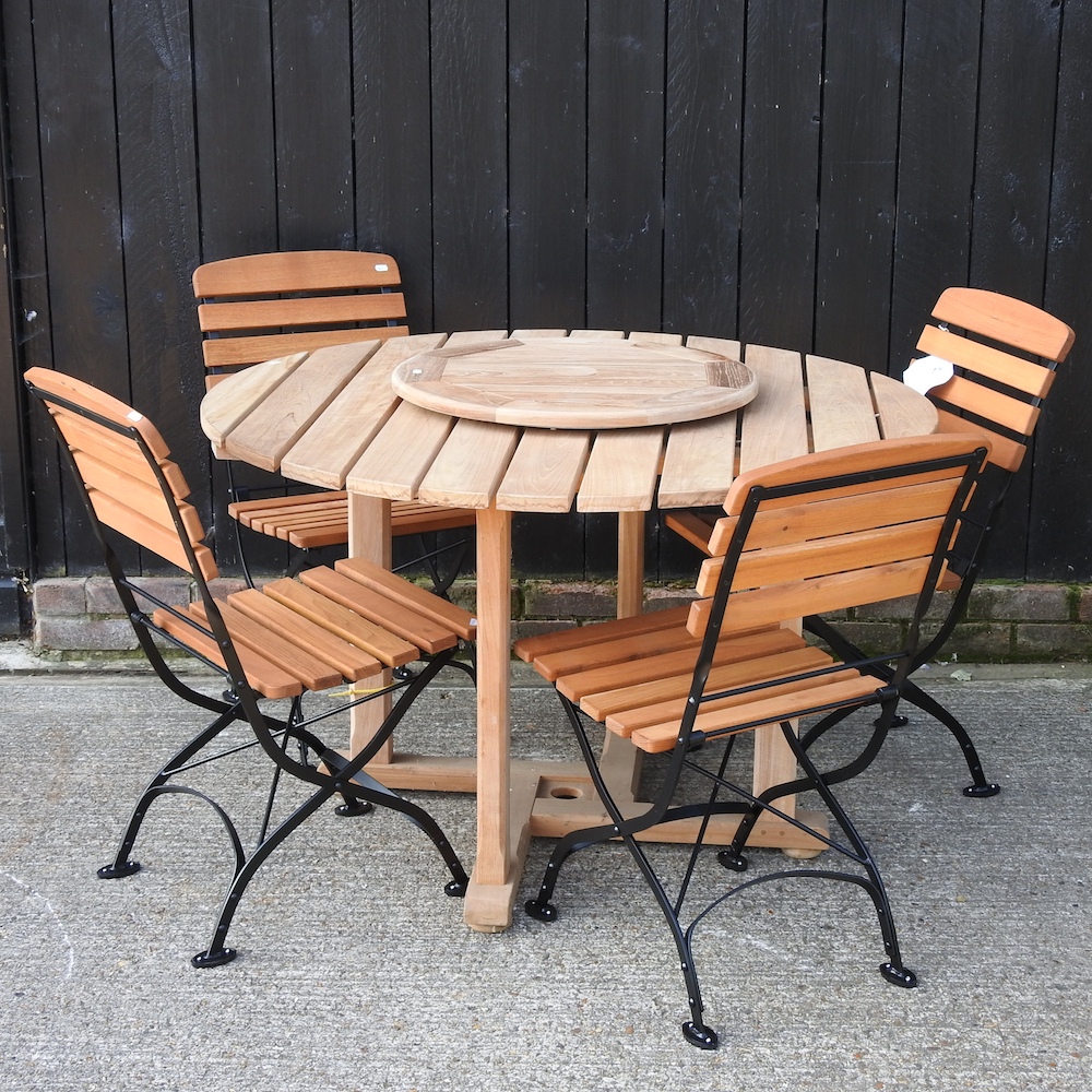 A teak circular garden table, 122cm diameter,