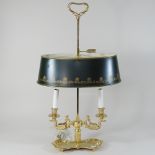 A brass and tole style table lamp and green shade,