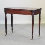 A Regency mahogany folding tea table, on reeded legs,