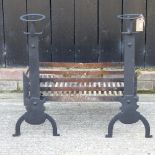 A black painted iron fire grate, together with a pair of fire dogs,