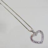 A 14 carat gold and diamond heart shaped pendant, 2cm wide, on a fine chain, 6.