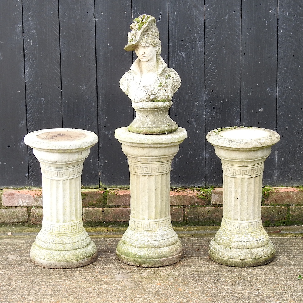 A reconstituted stone bust, on a column base, together with a pair of columns,