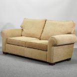 A beige upholstered sofa,