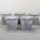 A set of five square galvanized metal planters,